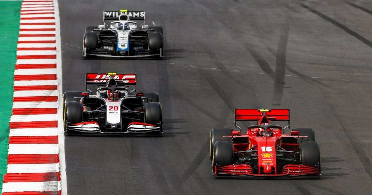 Archive photograph of a Ferrari leading a Haas and a Williams on track.